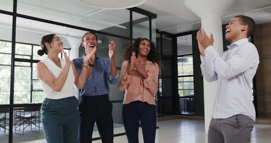 Diverse Team Celebrating Success with Smiles and Applause
