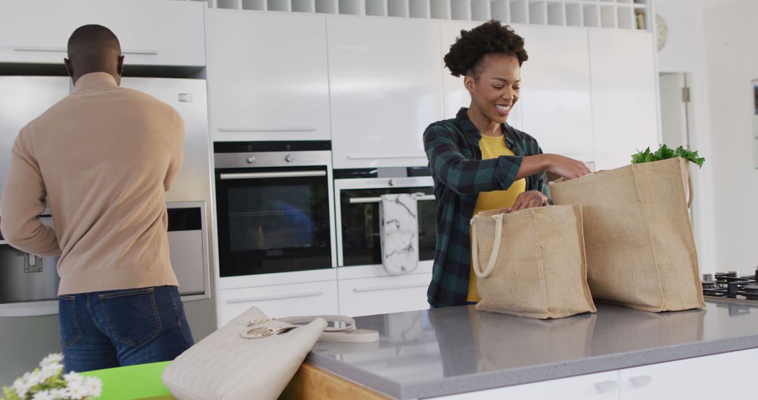 African American Couple Unpacking Groceries in Kitchen