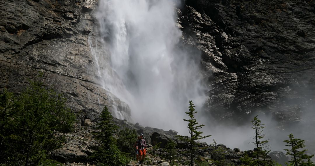 Hiker Enjoying Scenic Waterfall in Mountain Environment - Free Images, Stock Photos and Pictures on Pikwizard.com