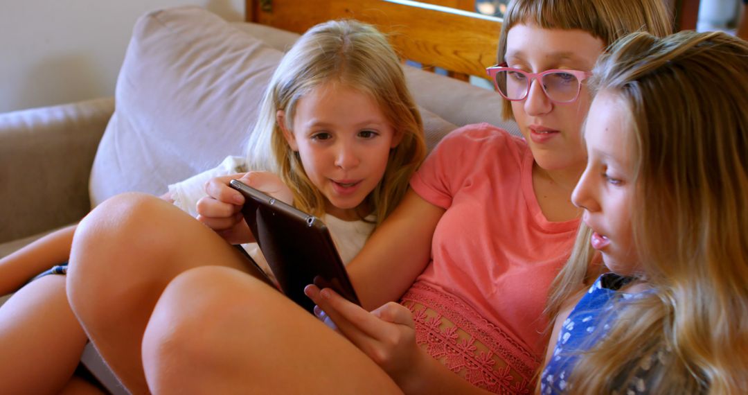 Children Engaging with Digital Tablet on Sofa at Home - Free Images, Stock Photos and Pictures on Pikwizard.com