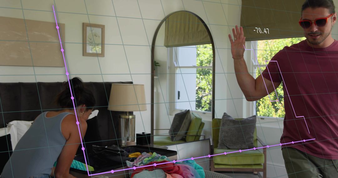 Couple packing clothes in bright bedroom with augmented reality tracking overlay