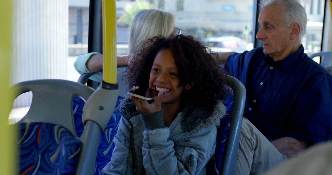 Girl Chatting on Smartphone While Riding a Bus with Passengers - Free Images, Stock Photos and Pictures on Pikwizard.com