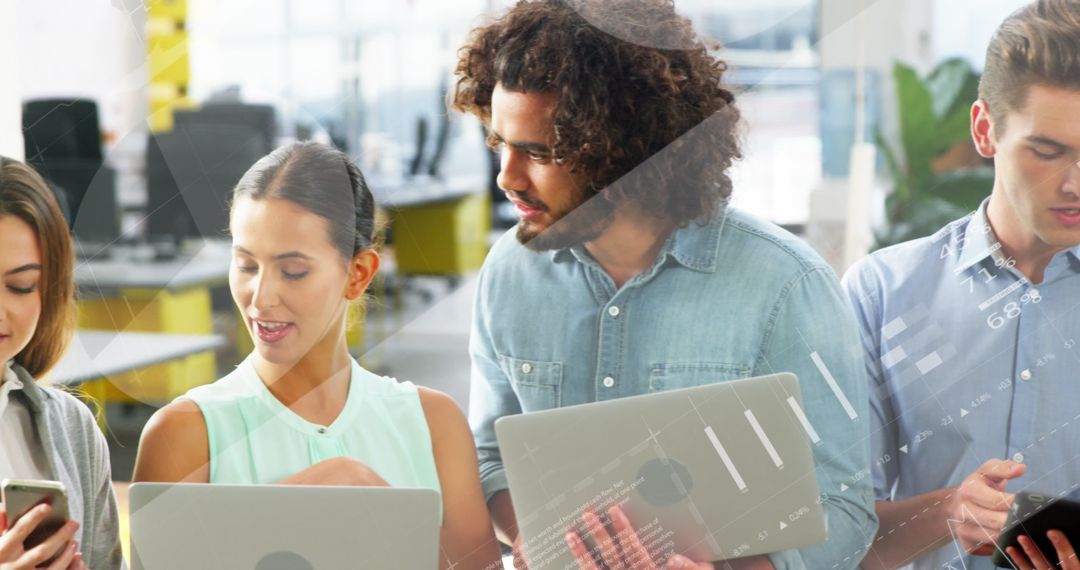 Diverse Team Collaborating on Business Data Analysis in Modern Office