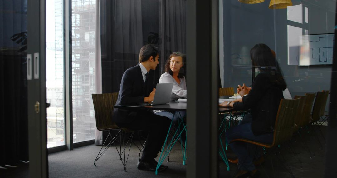 Professionals Collaborating on Project in Modern Conference Room