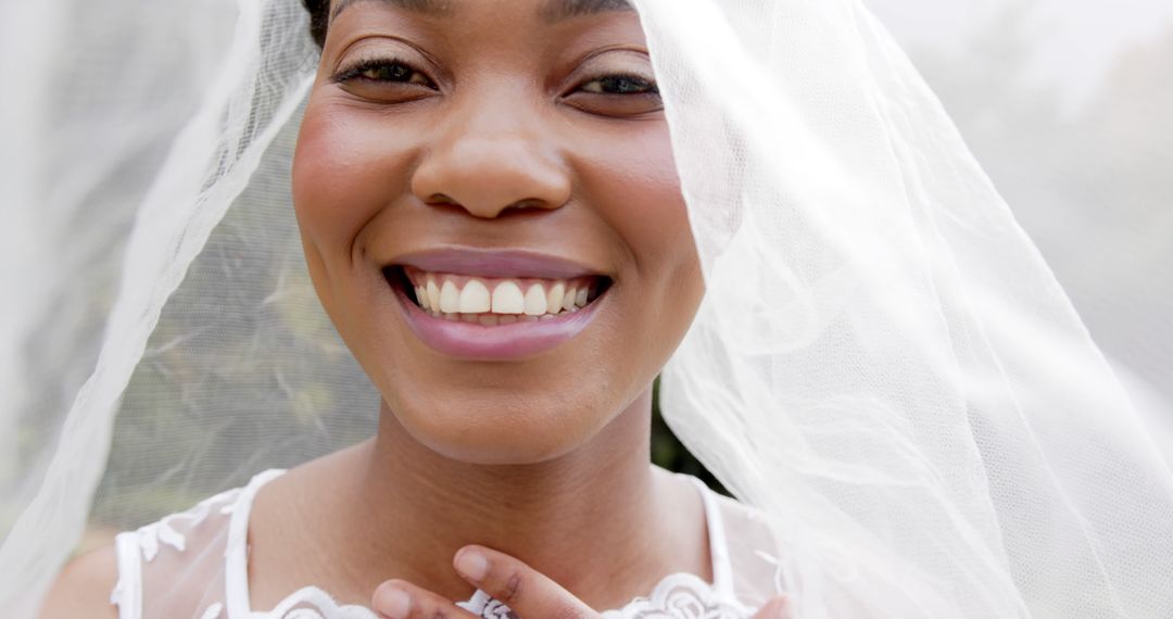 Beautiful Black Bride Smiling Under Wedding Veil on a Sunny Day - Free Images, Stock Photos and Pictures on Pikwizard.com