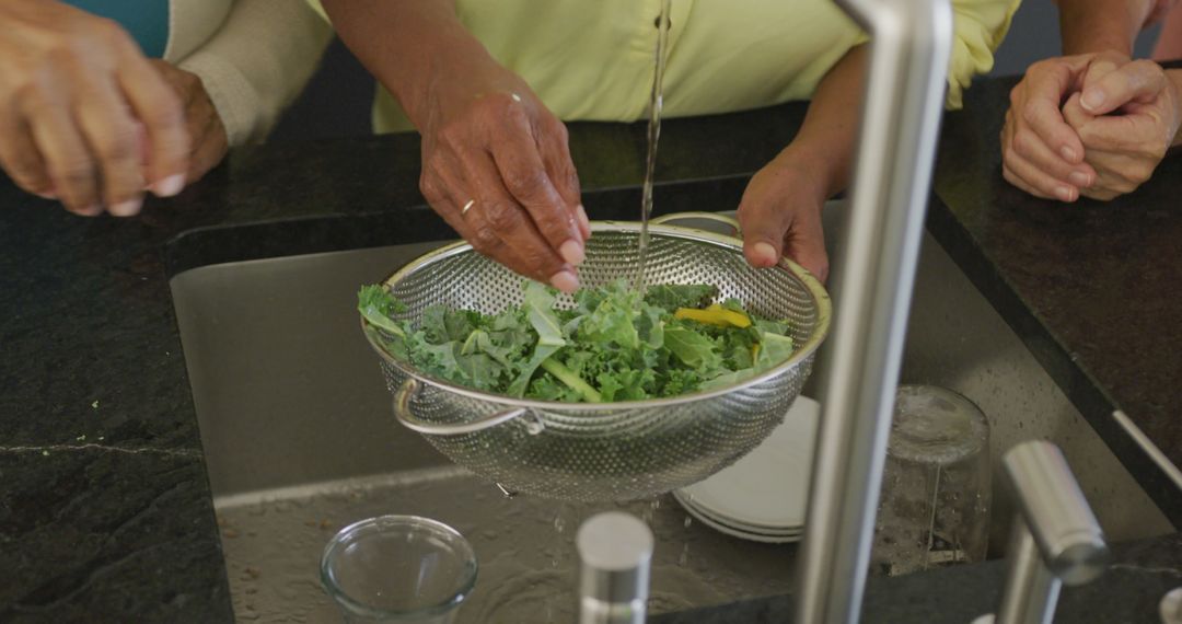 Mature Hands Washing Fresh Kale Leaves in Kitchen Sink - Free Images, Stock Photos and Pictures on Pikwizard.com