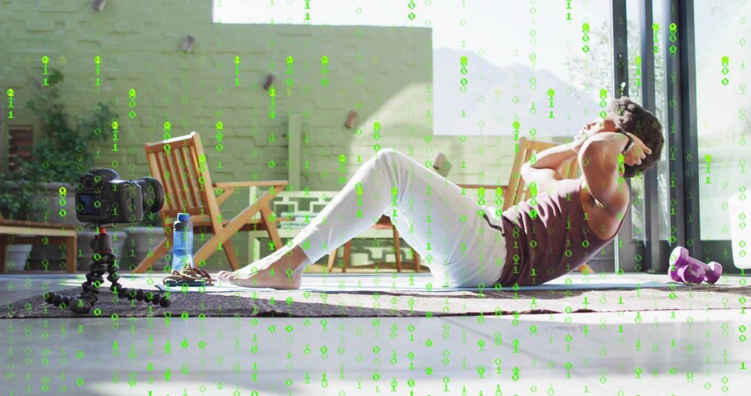 Man doing crunches on mat by sliding doors with DSLR recording home fitness routine