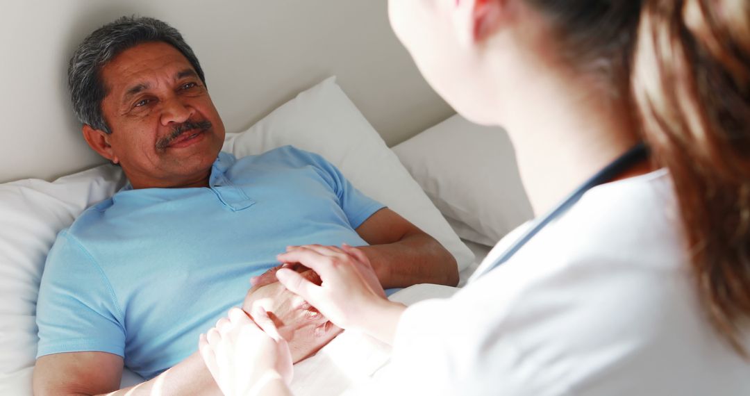 Nurse Comforting Elderly Patient Holding Hands - Free Images, Stock Photos and Pictures on Pikwizard.com