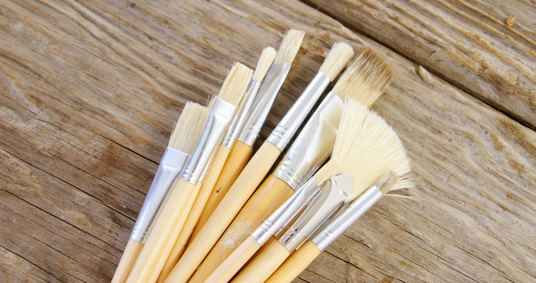 Variety of Artist Paintbrushes on Rustic Wooden Surface - Free Images, Stock Photos and Pictures on Pikwizard.com