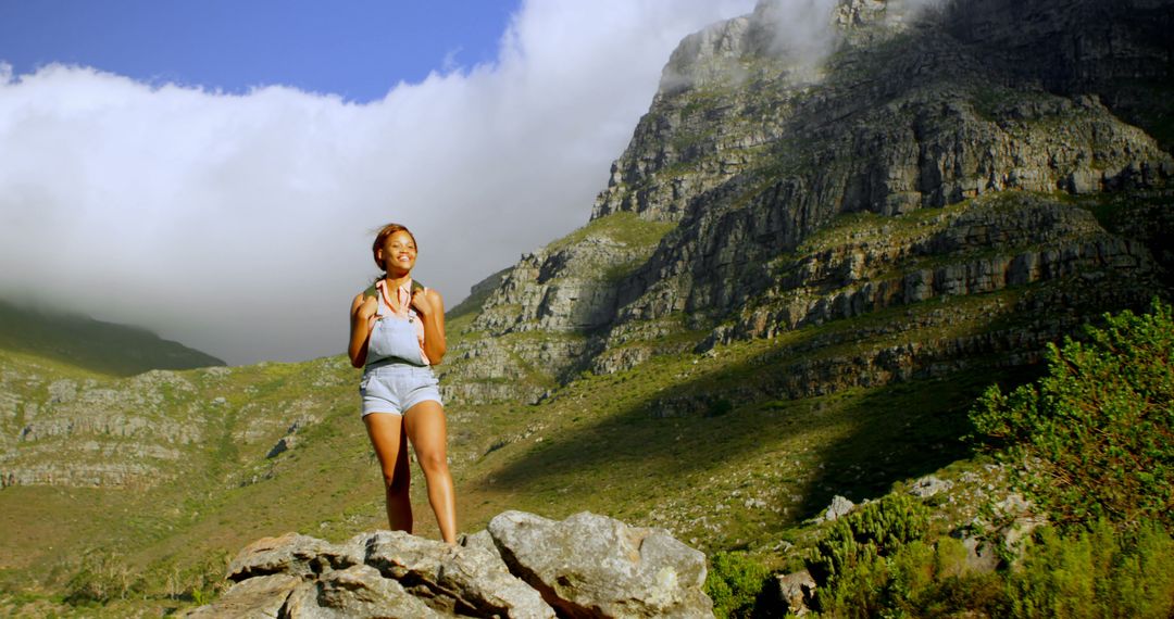 Woman Hiking in Majestic Mountains Under Blue Sky - Free Images, Stock Photos and Pictures on Pikwizard.com