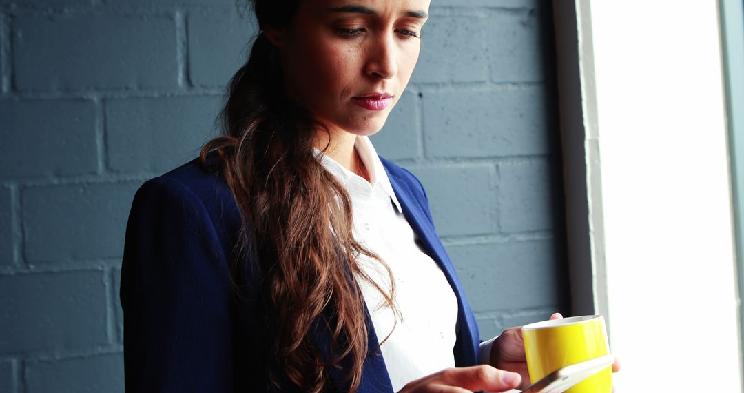 Businesswoman Holding Coffee Cup Reading Tablet - Free Images, Stock Photos and Pictures on Pikwizard.com