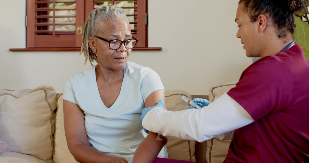Caring Nurse Assisting Senior with Injection at Home