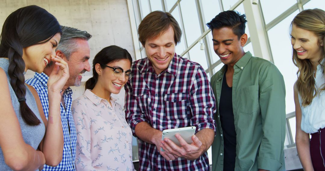 Diverse Creative Team Collaborating With Tablet in Modern Office