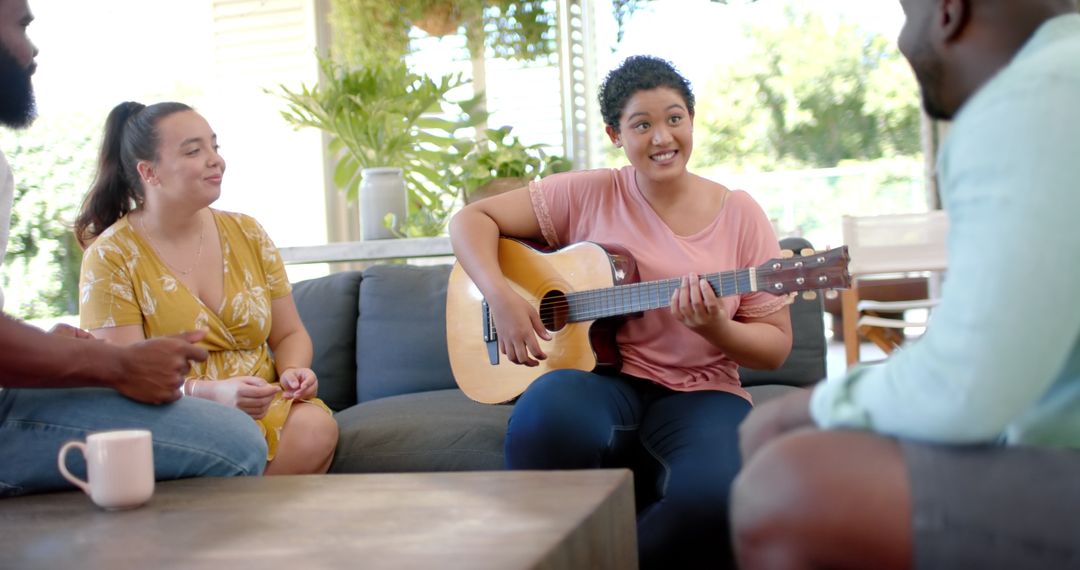 Diverse Group of Friends Relaxing at Home with Live Music