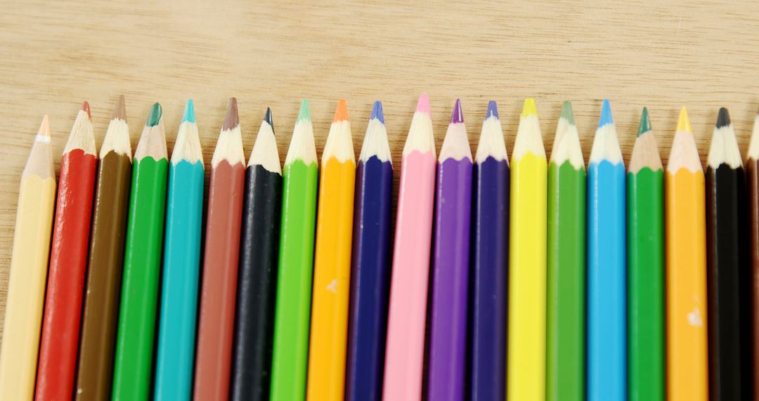 Colorful Row of Sharpened Colored Pencils on Wooden Surface - Free Images, Stock Photos and Pictures on Pikwizard.com