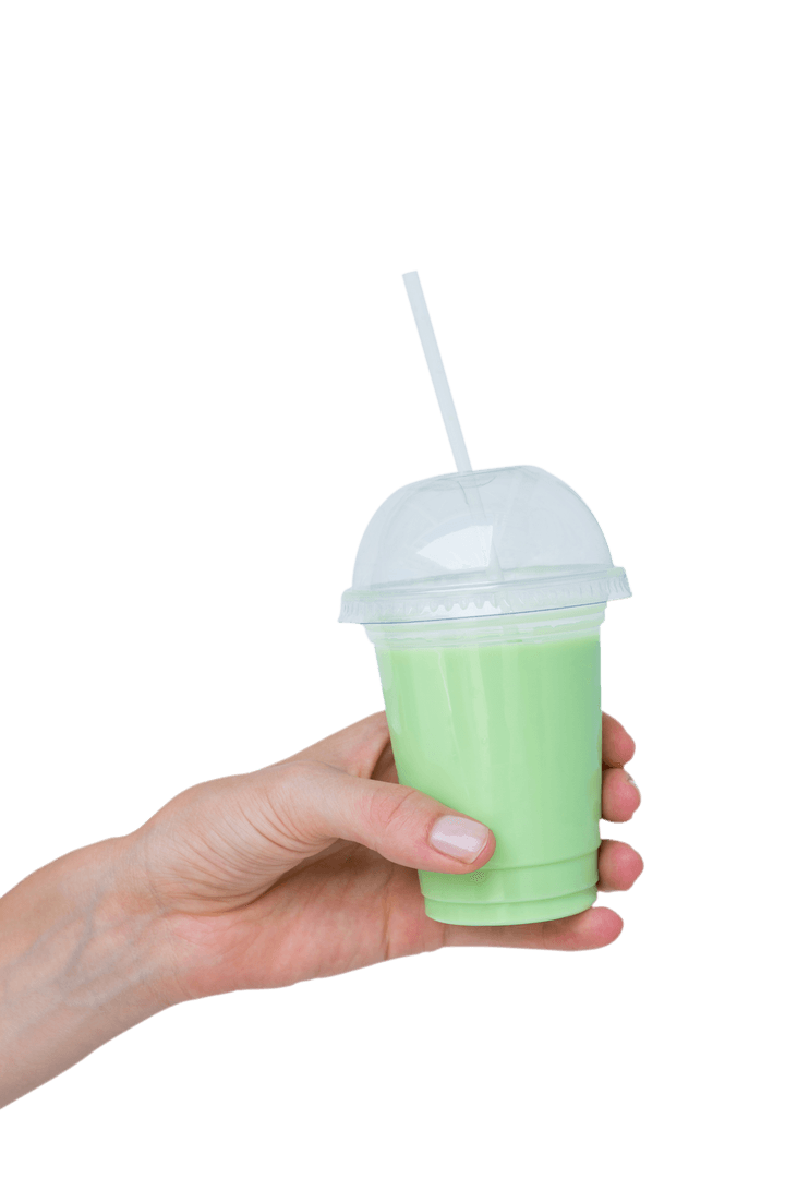 Hand Holding Transparent Cup with Green Smoothie