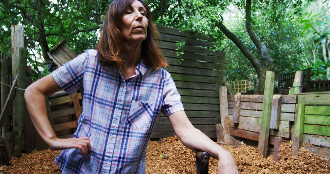 Confident Woman in Plaid Shirt in Rustic Outdoor Area - Free Images, Stock Photos and Pictures on Pikwizard.com