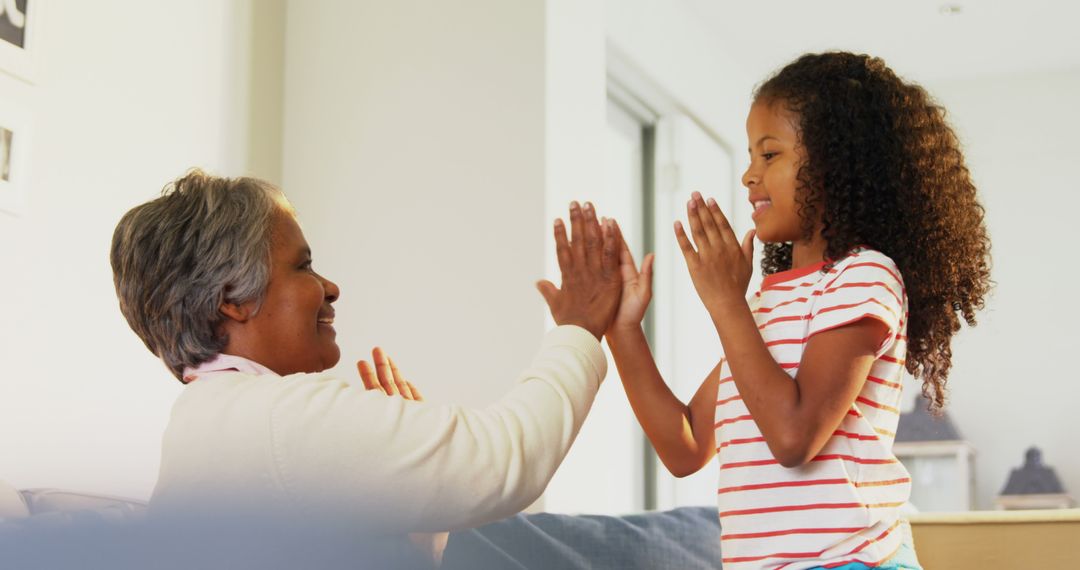 Grandmother and Granddaughter Playing Clapping Game Indoors - Free Images, Stock Photos and Pictures on Pikwizard.com