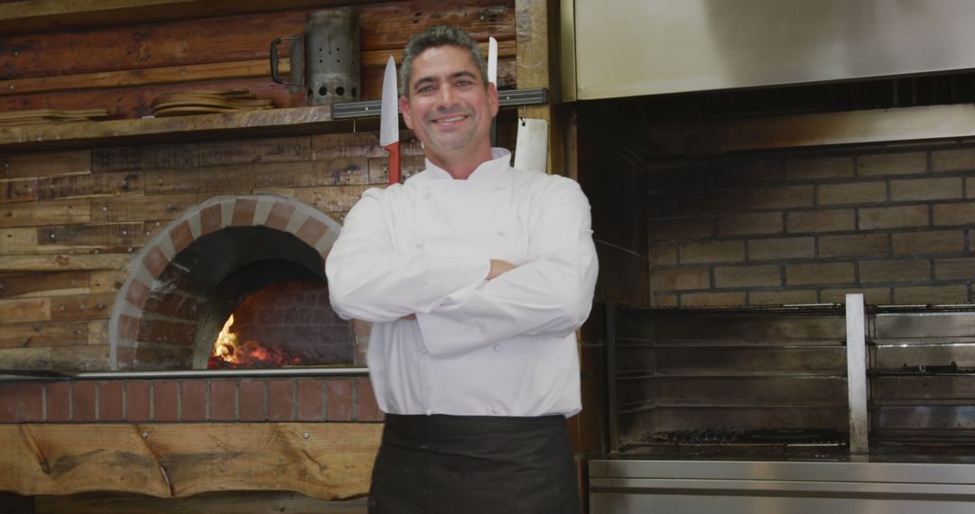 Smiling Chef Standing in Rustic Kitchen by Brick Oven - Free Images, Stock Photos and Pictures on Pikwizard.com