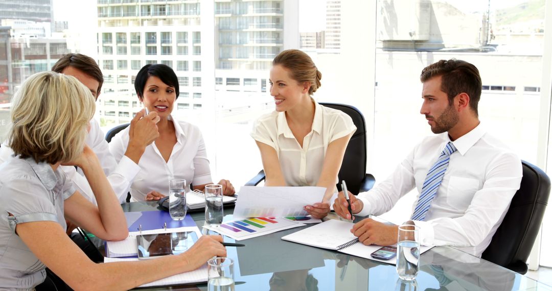 Team Discussion Around Table with Documents in Modern Office
