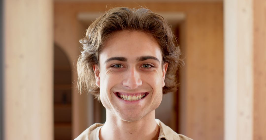 Smiling Man in Bright Minimalist Interior Corridor