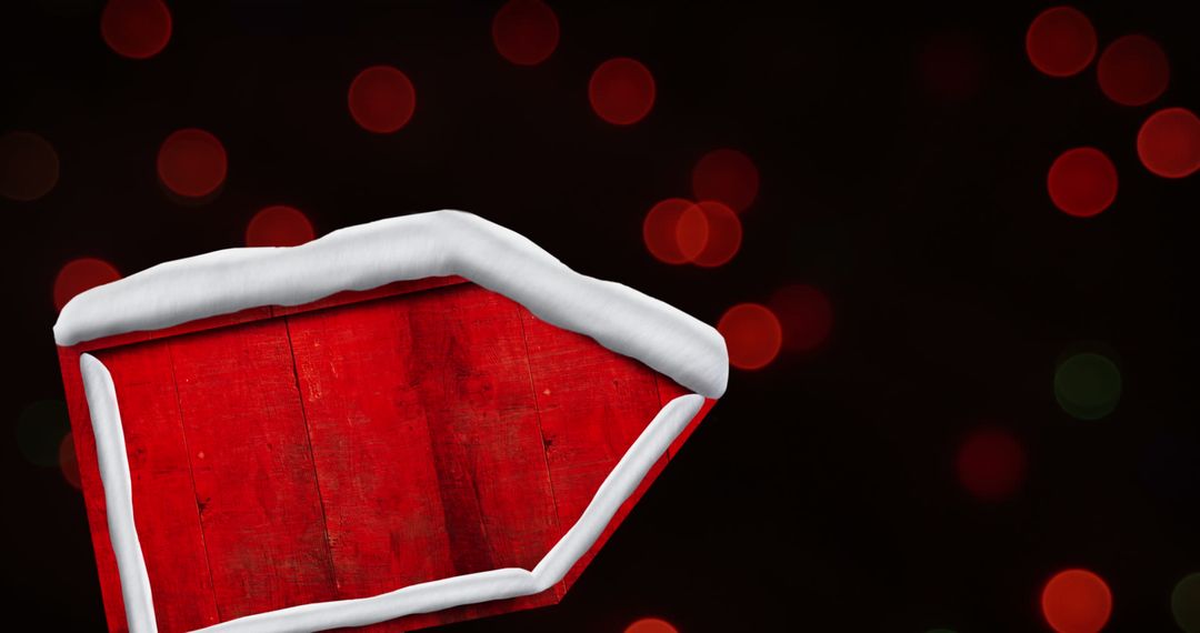 Snow-covered Red Sign Board with Festive Lights