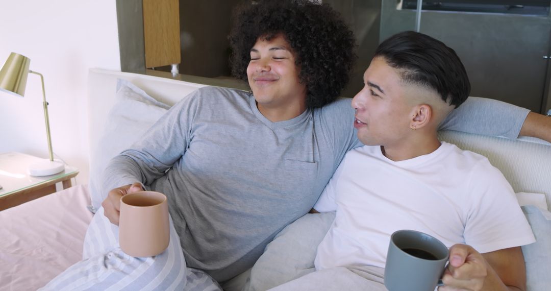 Diverse Pair Enjoying Coffee in Bed, Relaxing with Morning Cup