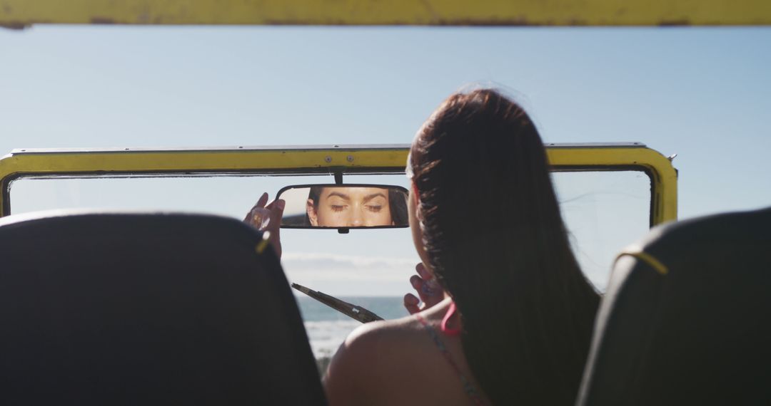 Woman Gazing In Rear View Mirror In Open-Top Beach Vehicle - Free Images, Stock Photos and Pictures on Pikwizard.com