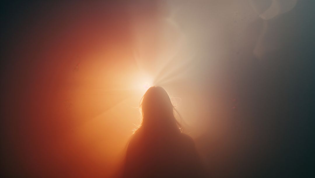 Silhouette Facing Intense Backlight with Dramatic Haze, Halo Rays and Cinematic Lens Flare