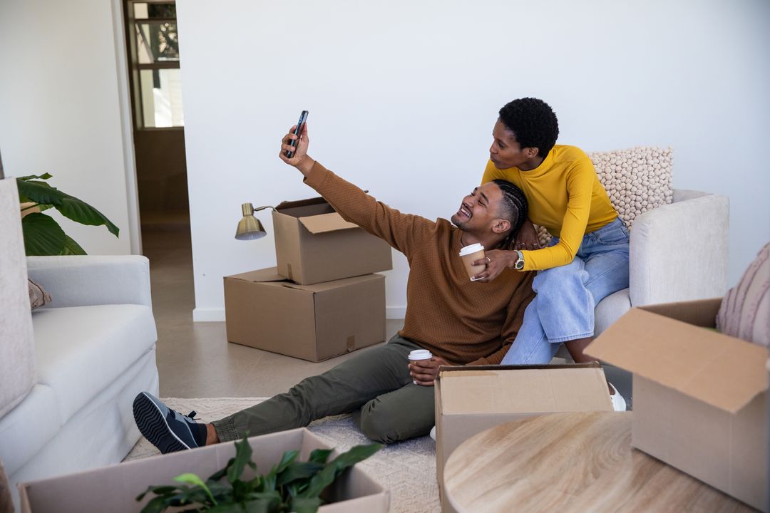Diverse Couple Taking Selfie While Unpacking in New Home