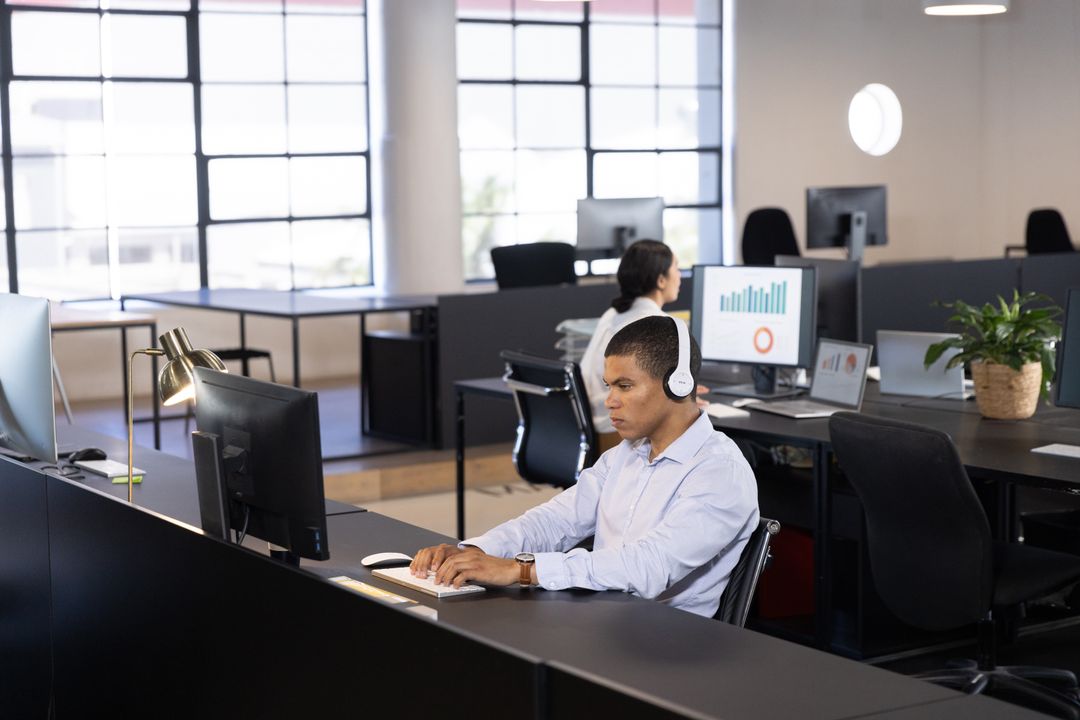 Focused Team Working in Modern Open-Plan Office with Technology