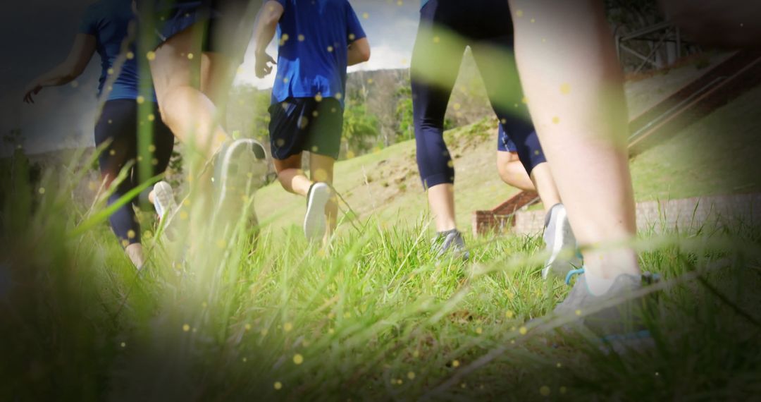 Group of Runners Ascending Grassy Hill in Motion