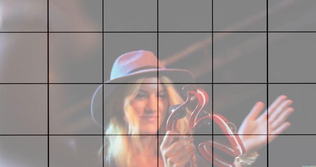 Smiling Performer Shaking Tambourine on Concert Stage