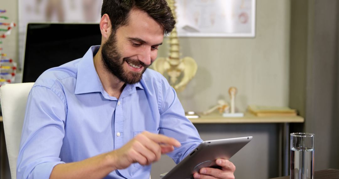 Smiling Bearded Man Working on Digital Tablet in Office - Free Images, Stock Photos and Pictures on Pikwizard.com