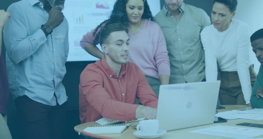 Team Analyzing Data on Laptop in Modern Conference Room