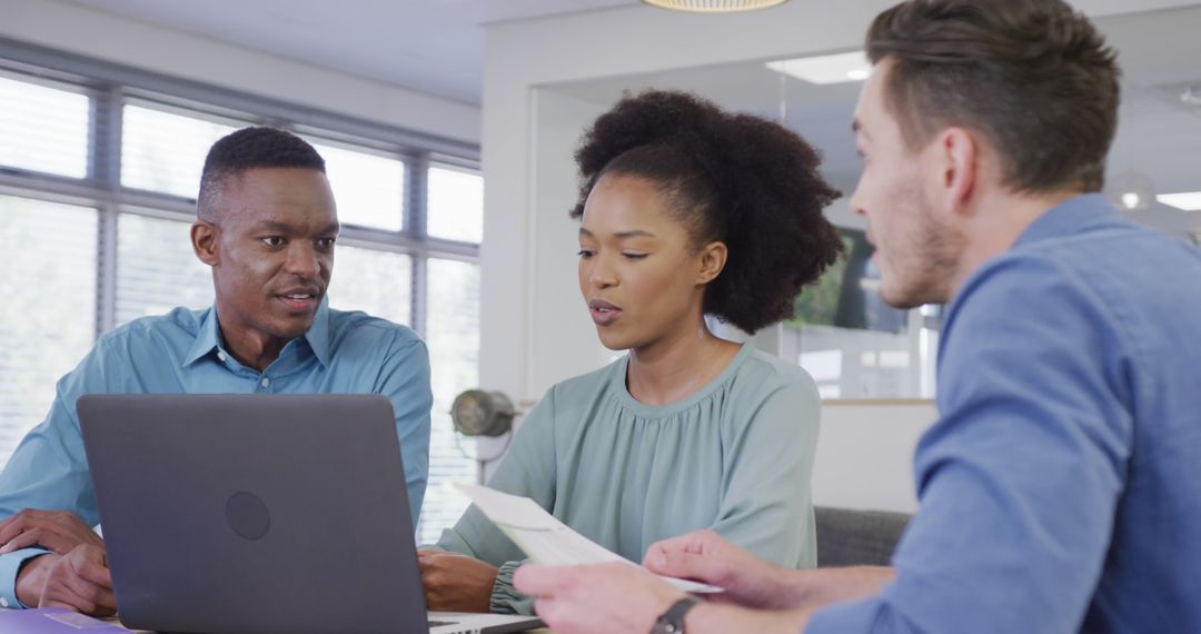 Diverse Team Collaborating on Financial Project in Modern Office