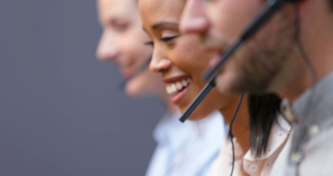 Diverse Customer Support Team Smiling with Headsets