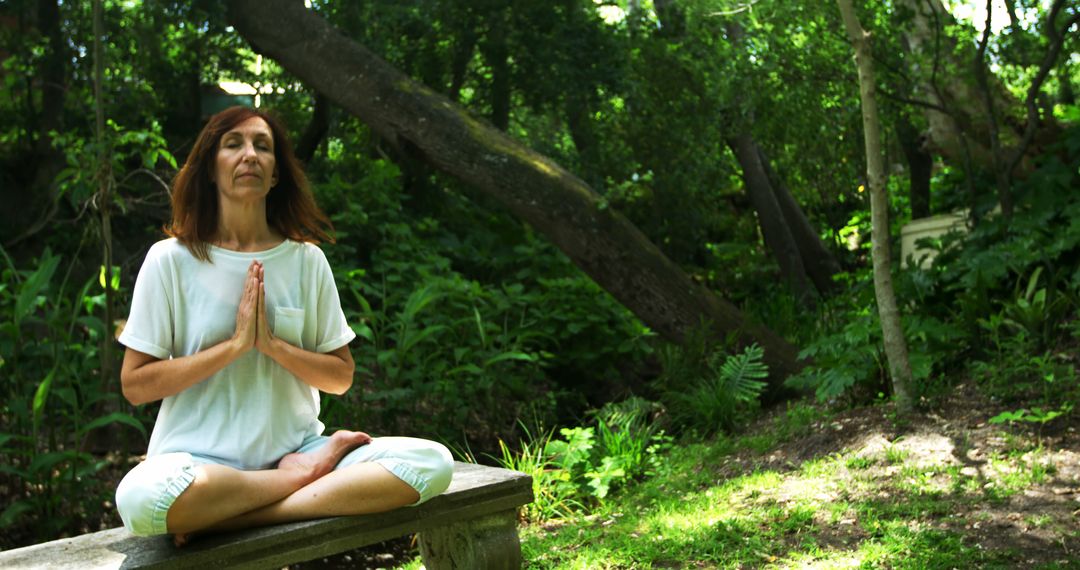 Middle-aged woman practicing mindfulness meditation in forest - Free Images, Stock Photos and Pictures on Pikwizard.com