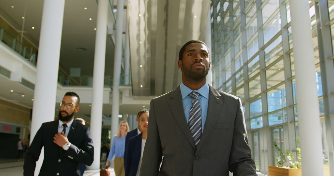 Group of Diverse Business People Walking Confidently in Modern Office Building - Free Images, Stock Photos and Pictures on Pikwizard.com