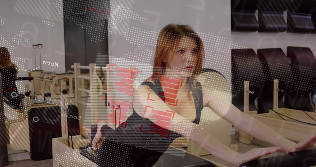 Woman kneeling and stretching on Pilates reformer in modern studio with mirror reflection