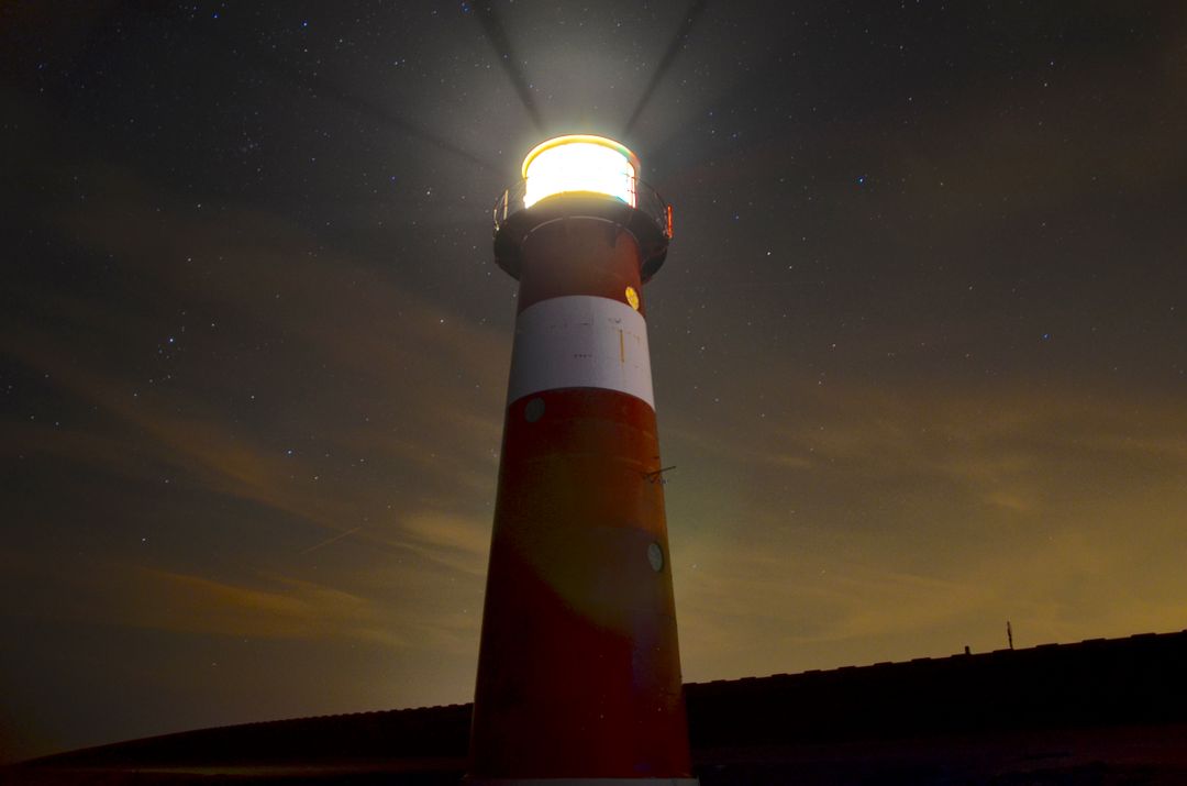 Illuminated Lighthouse at Sunset with Starry Sky - Free Images, Stock Photos and Pictures on Pikwizard.com