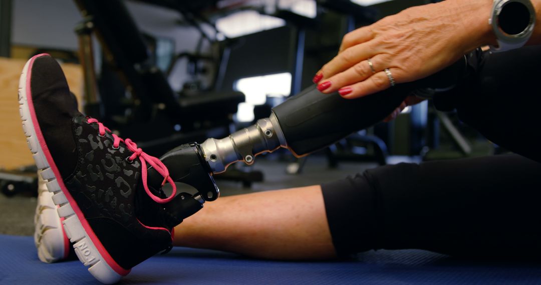 Female Athlete with Prosthetic Leg Stretching in Gym - Free Images, Stock Photos and Pictures on Pikwizard.com