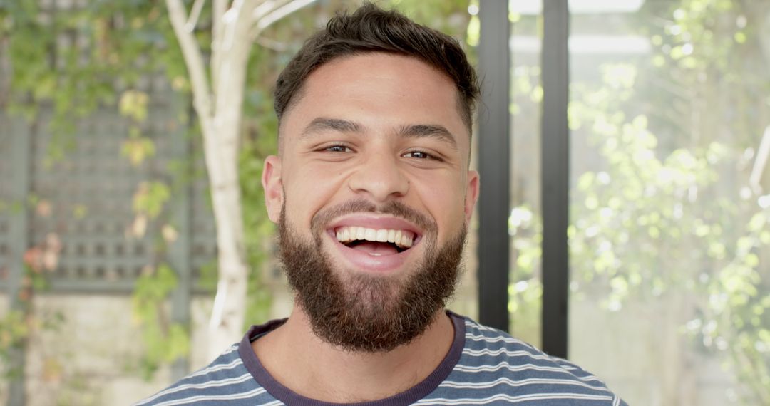 Young Man Smiling Naturally in Welcoming Minimalistic Space