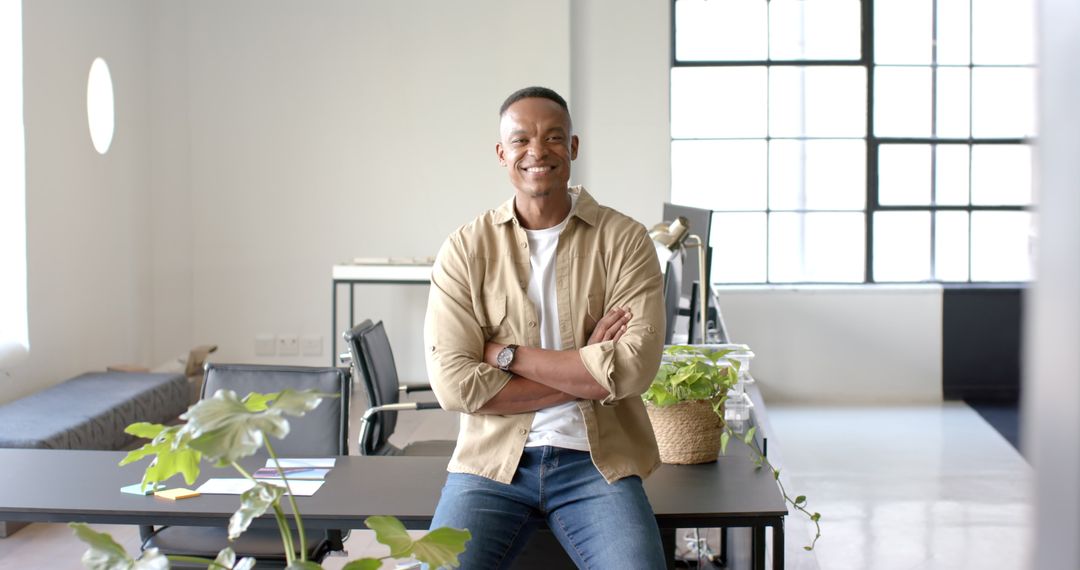 Smiling Businessman Sitting Confidently in Modern Office