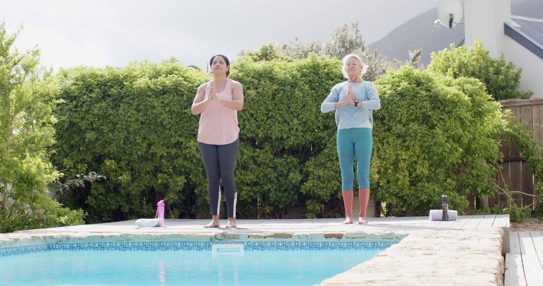 Senior and Mid-Aged Women Practicing Yoga by Outdoor Pool - Free Images, Stock Photos and Pictures on Pikwizard.com