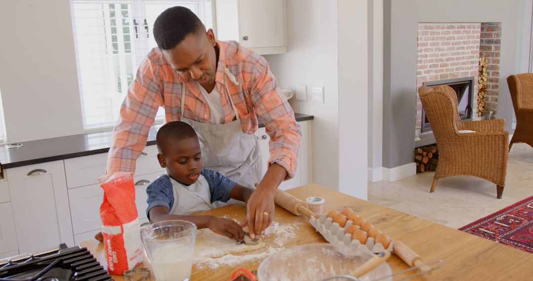 Father and Son Baking Cookies Together in Bright Kitchen