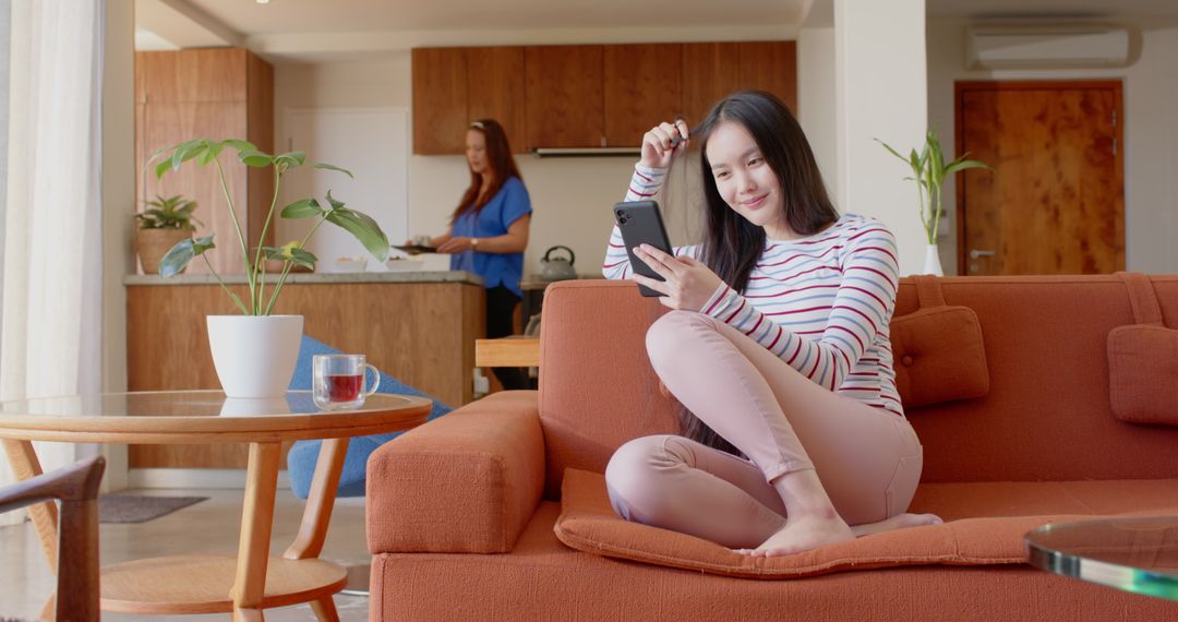 Mother and Daughter Relaxing at Home, Comfortable Modern Living Room