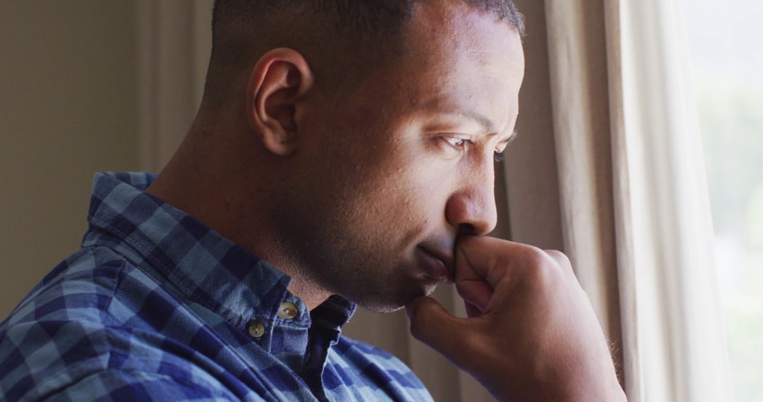 Pensive Man Contemplating by Sunlit Window