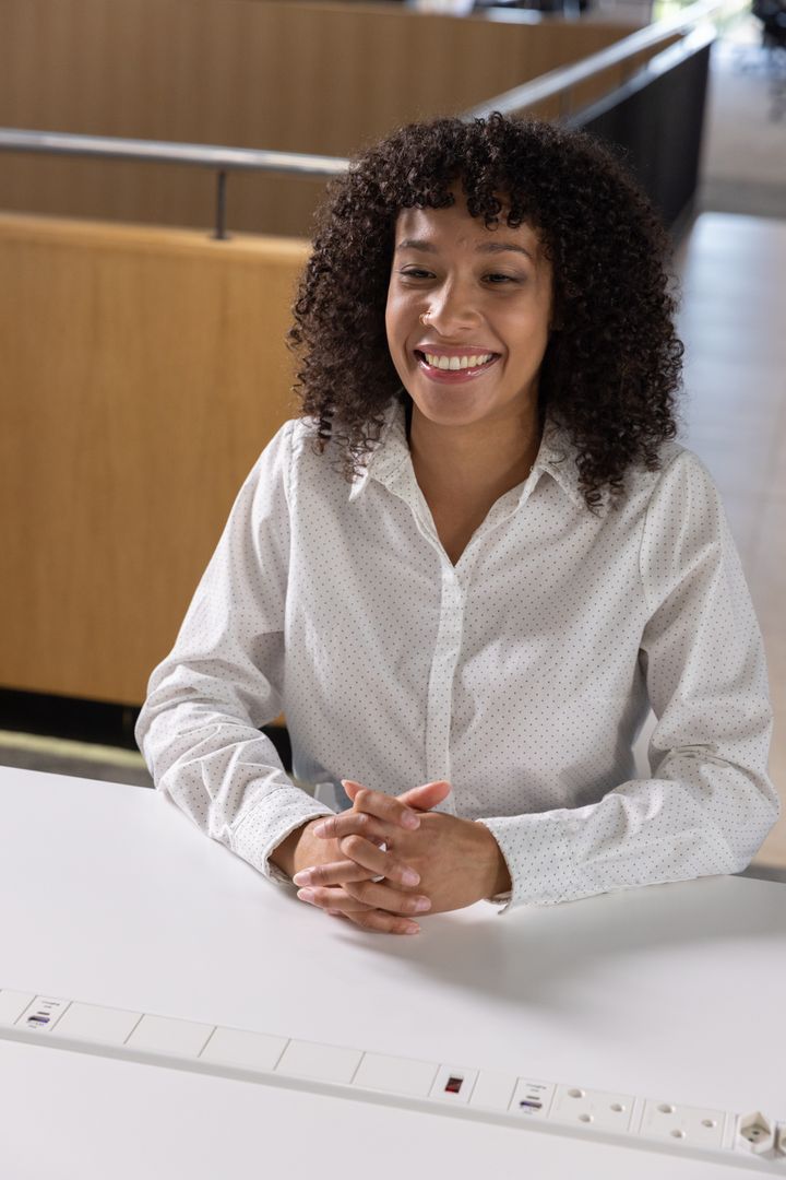 Smiling Professional Woman Using Workspace Power Outlet