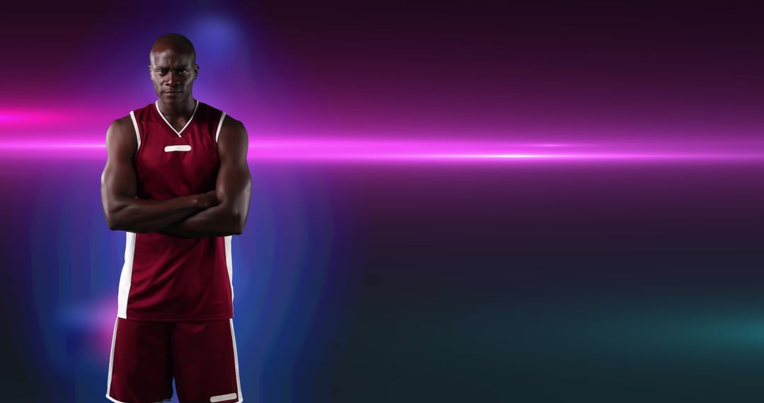 Focused Basketball Player with Arms Crossed on Purple Background